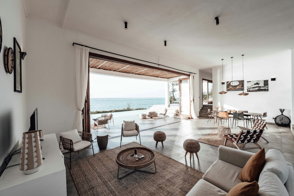 Luxury open-plan seaside home interior in Cornwall with ocean views, symbolising financial success and lifestyle freedom from smart tax planning.
